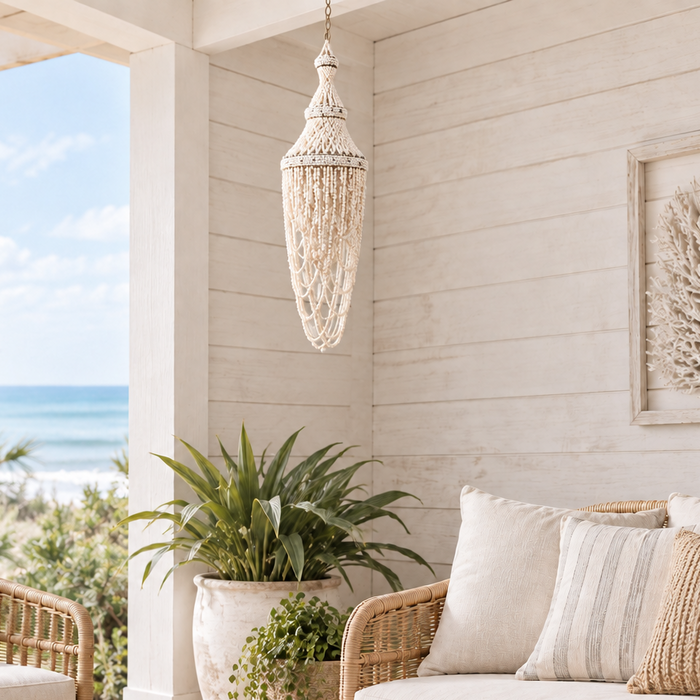 A bohemian-style beaded chandelier pendant in cream and white beads with silver-toned metal accents, shown against a plain white background.