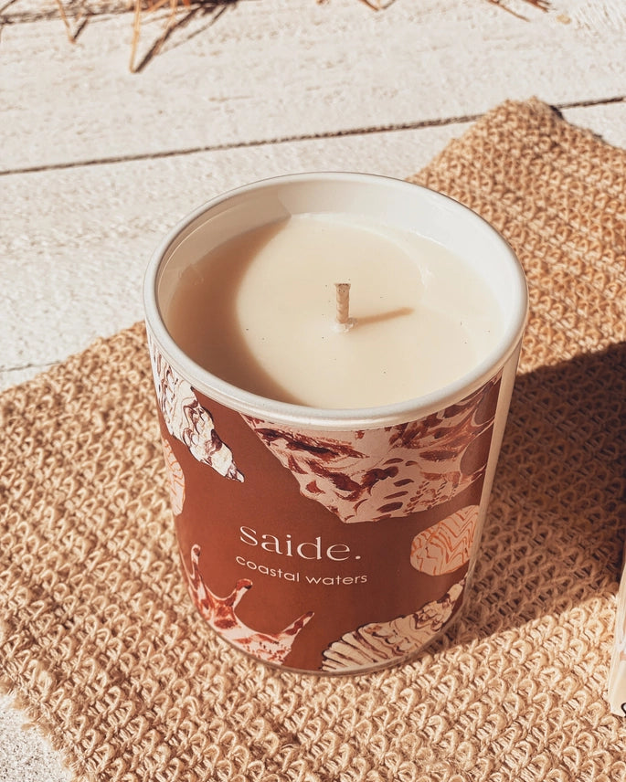 Oceana by Saide vegan soy candle with gold foil packaging designed by Caitlin Hope styled in a modern coastal home setting