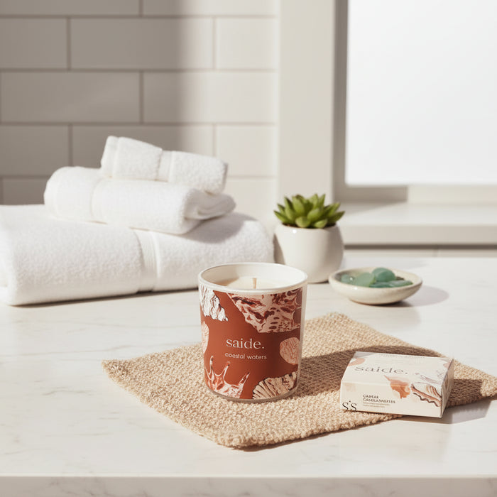 Oceana by Saide vegan soy candle with gold foil packaging designed by Caitlin Hope styled in a modern coastal home setting