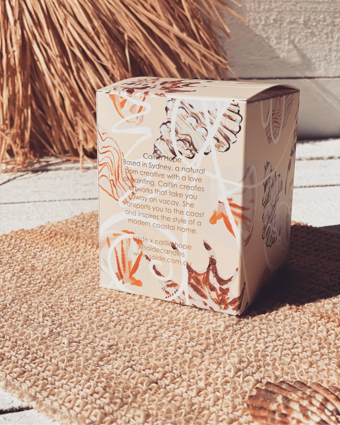 Oceana by Saide vegan soy candle with gold foil packaging designed by Caitlin Hope styled in a modern coastal home setting