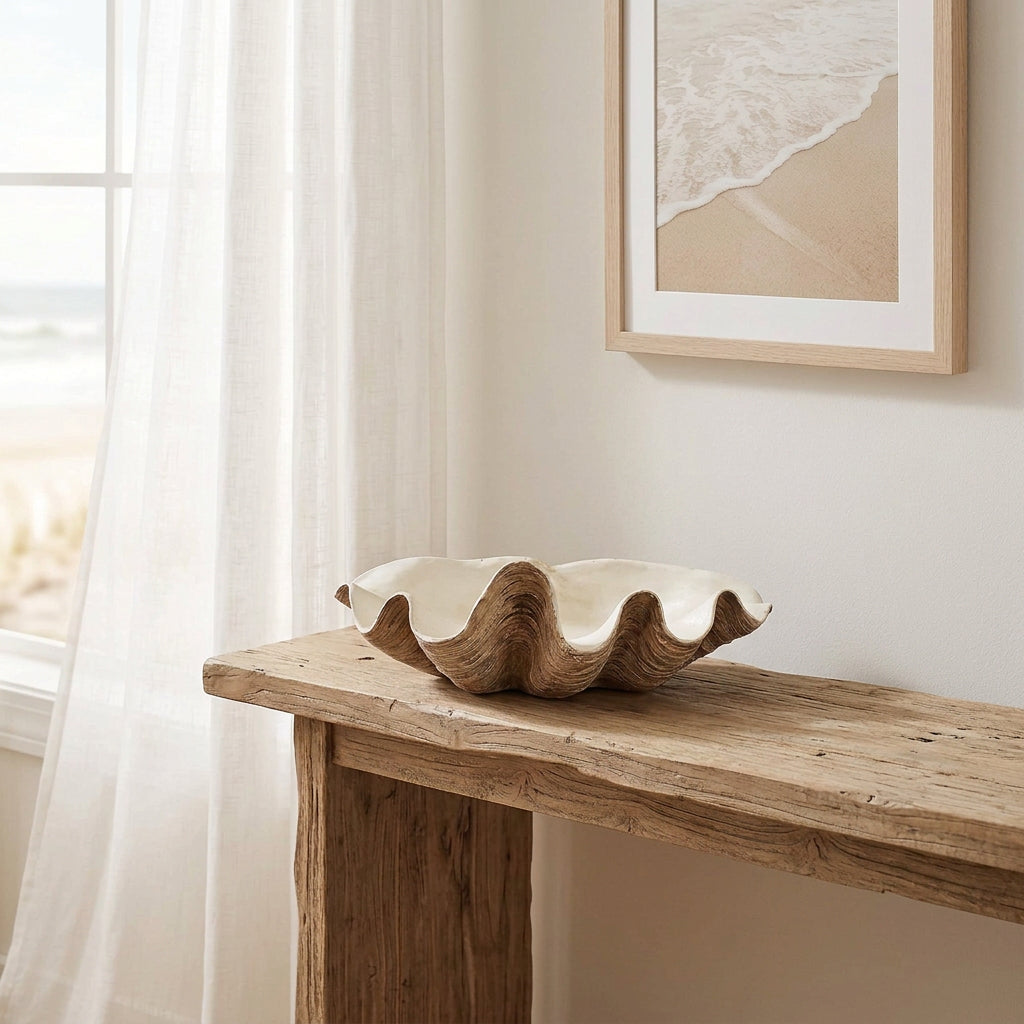 vintage resin clam shell styled on a rustic console in a beach house with neutral decor