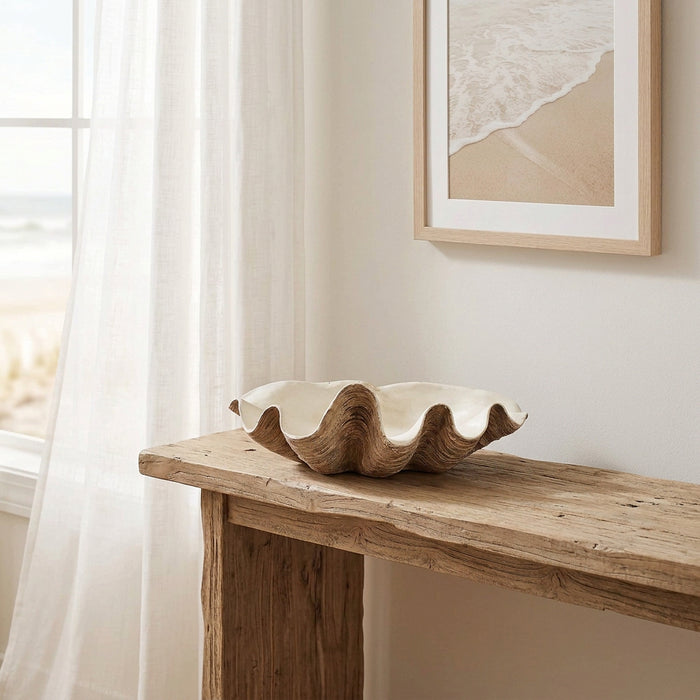 vintage resin clam shell styled on a rustic console in a beach house with neutral decor