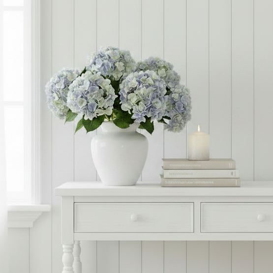 Add timeless elegance with our Faux Blue Hydrangea Stem featuring multi tonal, softly blended blue, ivory, and green petals. Perfect for coastal, Hamptons, and modern home styling.