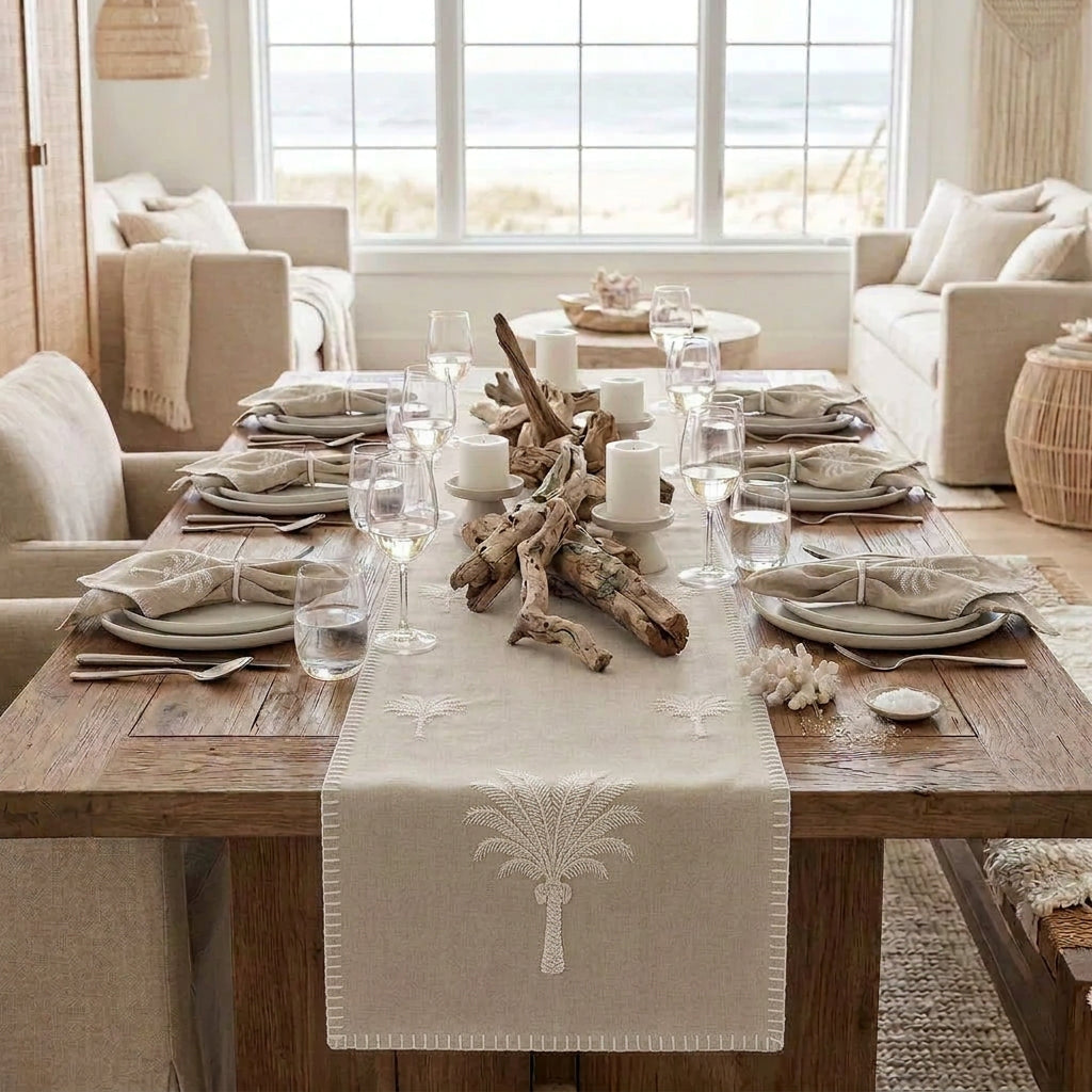 Bring tropical charm to your table with our Island Sand Palm cotton table runner, featuring an embroidered palm tree motif and decorative blanket stitch edging.