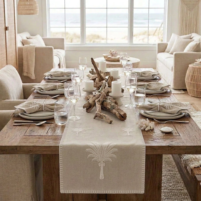 Bring tropical charm to your table with our Island Sand Palm cotton table runner, featuring an embroidered palm tree motif and decorative blanket stitch edging.