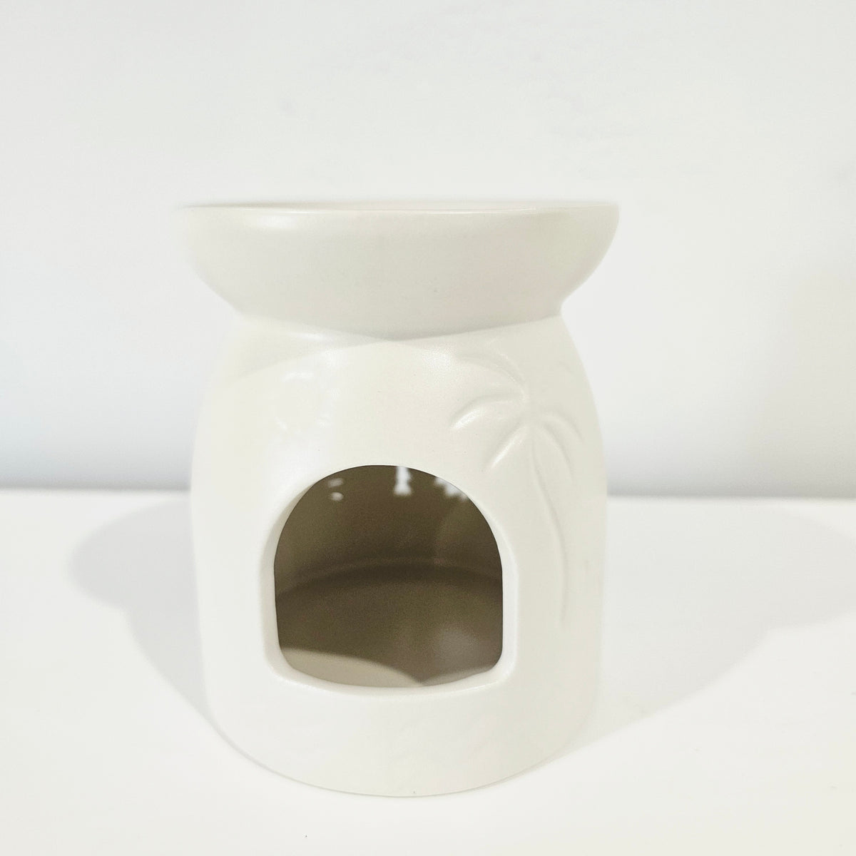 Lumi Coast Ceramic Oil Burner with intricate cut-out design for coastal home decor