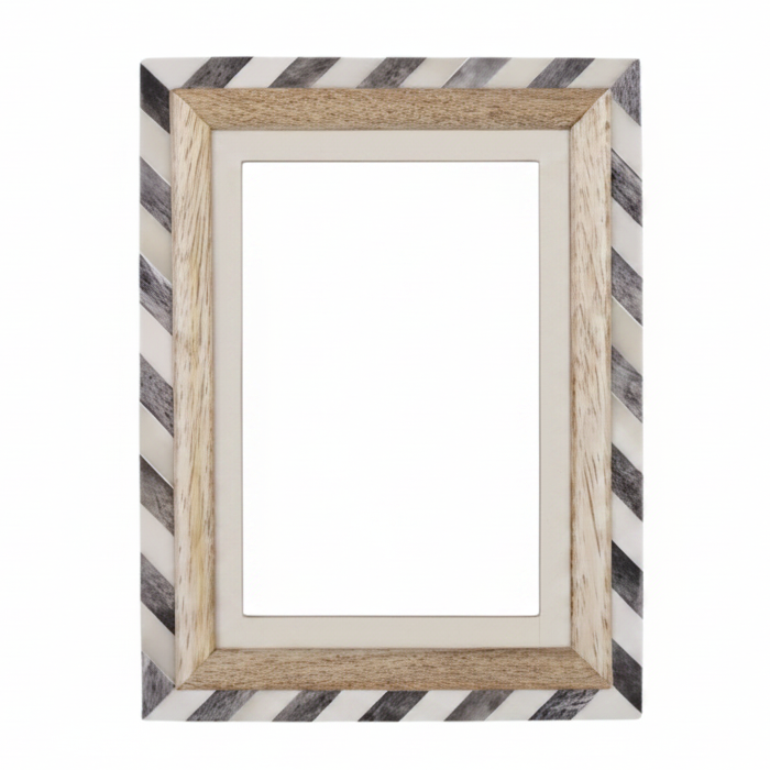 A rectangular picture frame with a striped border in black and white, featuring a light natural wood inner frame and a cream mat. 