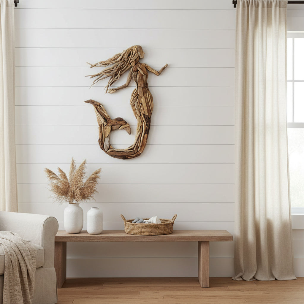Create a stunning coastal statement with the Seraphina Driftwood Mermaid Wall Art. Handcrafted from natural driftwood, this 80cm wall décor adds timeless beach house charm and artisan style to any home.