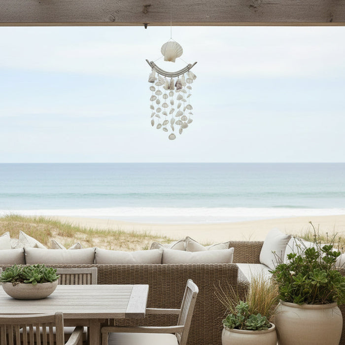 Add coastal charm with the Solange Rattan & Shell Wind Chime. Featuring a white rattan rod and shell hanger, perfect for beach-style interiors.