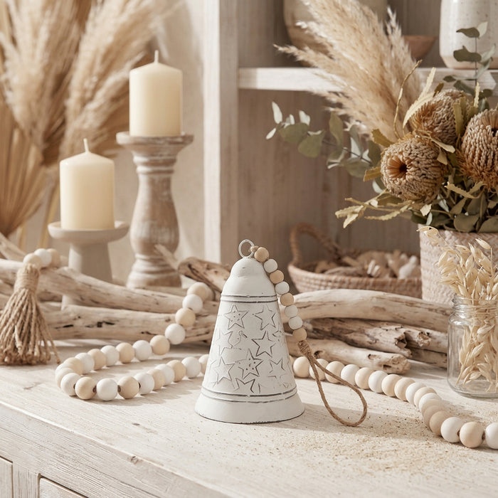 White metal christmas bell with star design and wooden bead accent