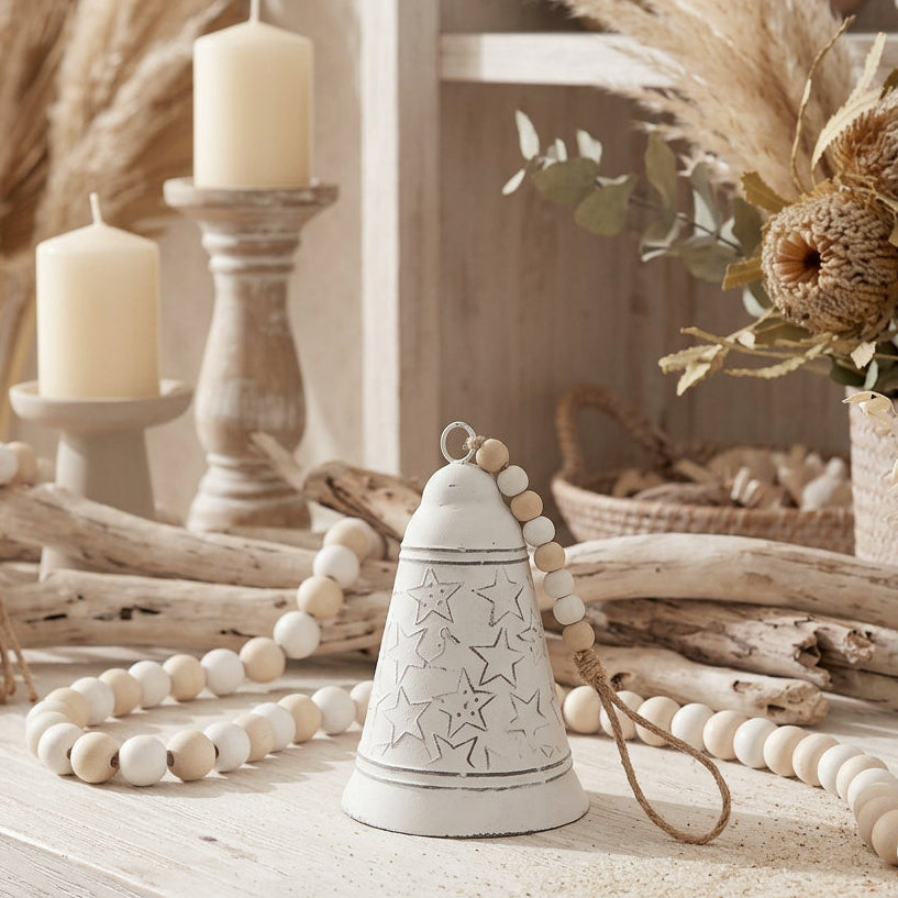 white metal christmas bell with stars and bead accents for coastal farmhouse christmas