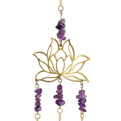 Decorative hanging with gold lotus design, purple beads, and crystal elements on a white background