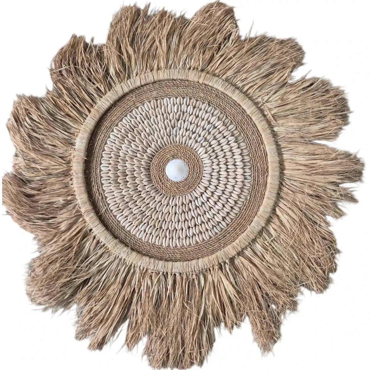 Shop the Tulum Cowrie Shell Wall Hanging, crafted from natural raffia and cowrie shells. A statement piece for tropical, coastal and boho interiors.
