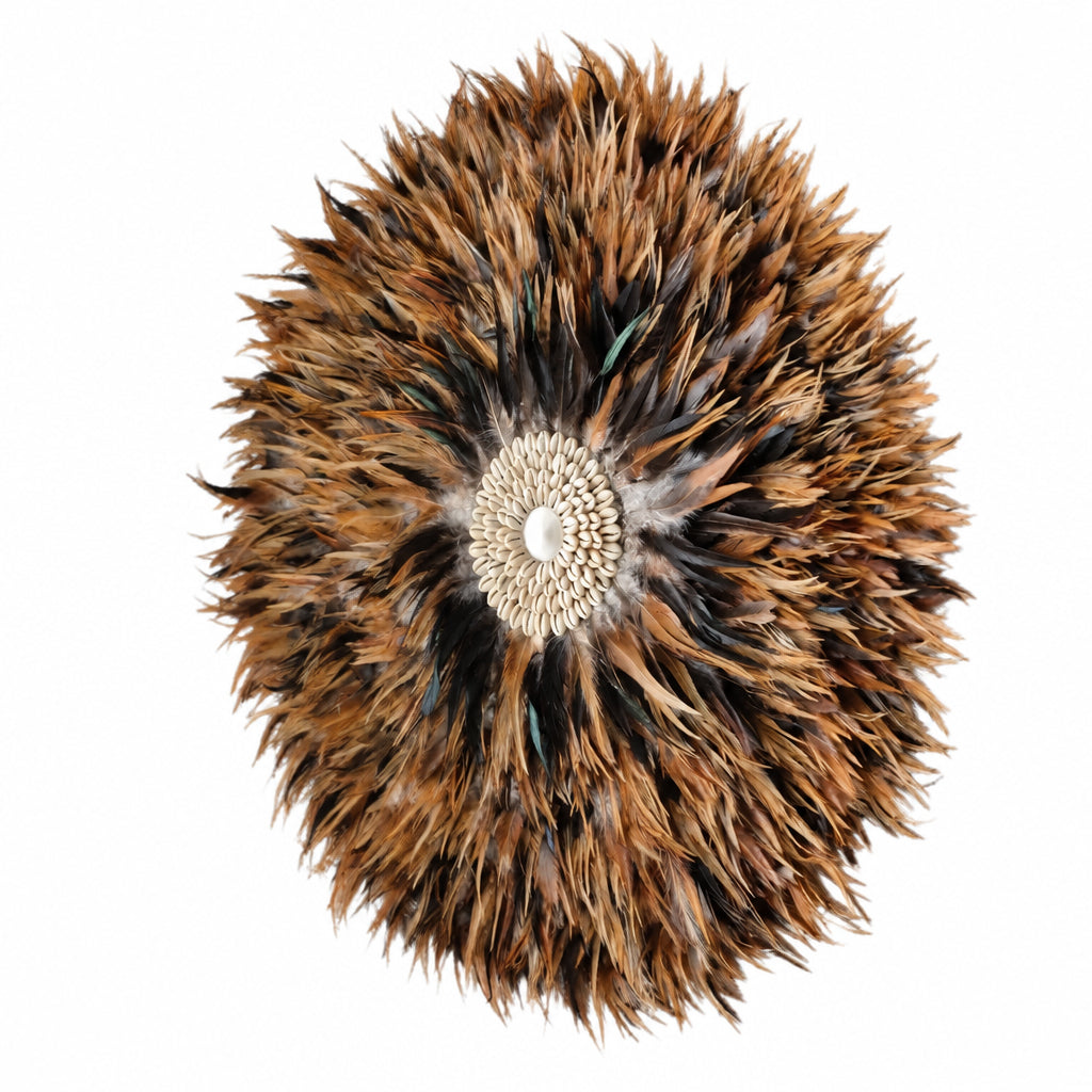 Zuri Feather Juju Wall Decor fluffy feather wall hanging or decorative piece made of layered brown, black, and tan feathers with a textured cream center, shown on a plain white background.